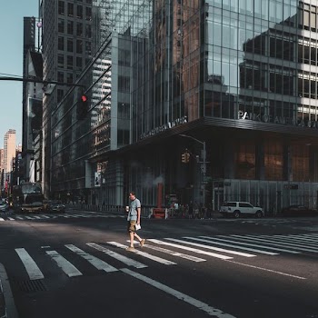 man crossing street on pedestrian lane