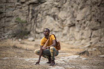 Man Crouching On Ground 