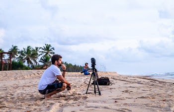Man Crouching on Shore