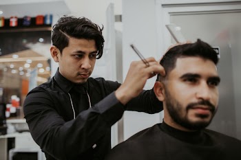 Man Cutting Another Man's Hair