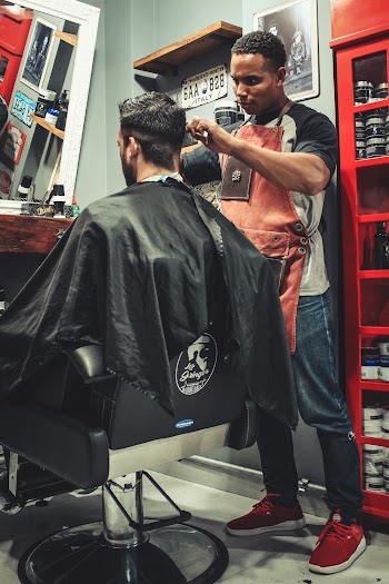 Man Cutting Hair Man While Sitting on Barber's Chair