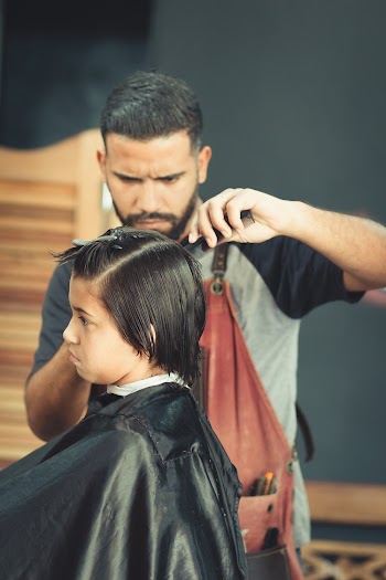 Man Cutting Hair of a Boy