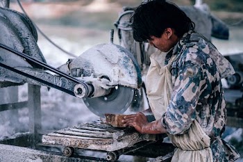 man cutting wood