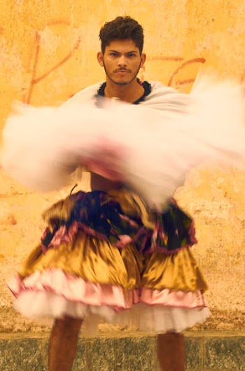 Man Dancing Near Orange Wall