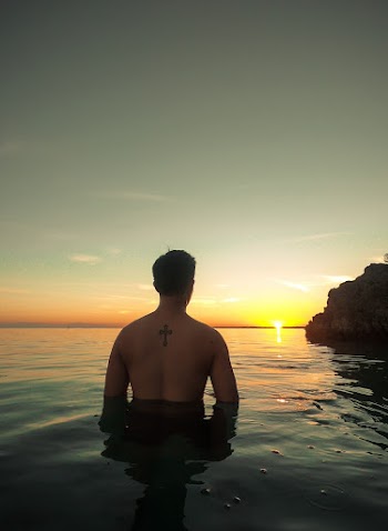 Man Dipped In The Sea During Golden Hour