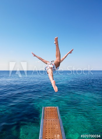 Man diving from yacht