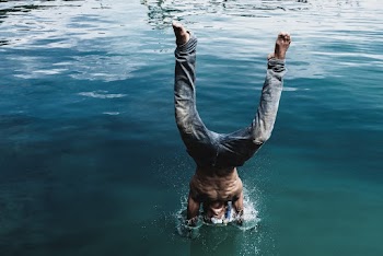 Man Diving into Body of Water