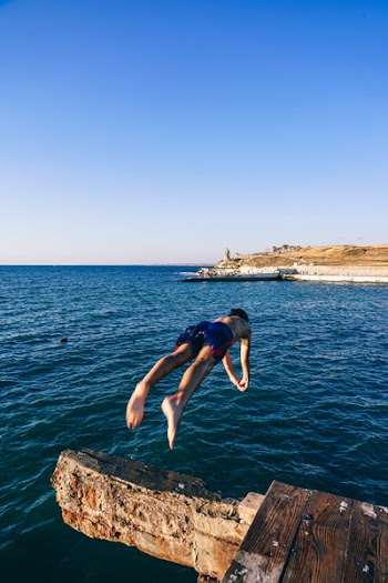 Man Diving on Body of Water
