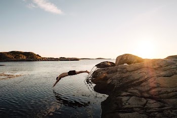 man diving on body of water