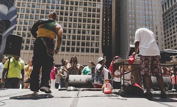 man doing concert in front of the crowd at daytime
