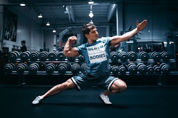 man doing flex in shallow photo