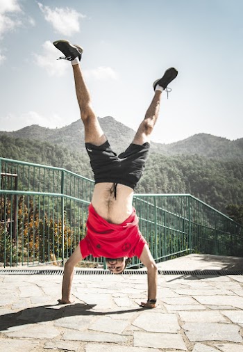 Man Doing Hand Stand on Pavement