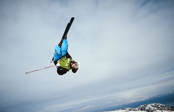 man doing ice skate trick mid air