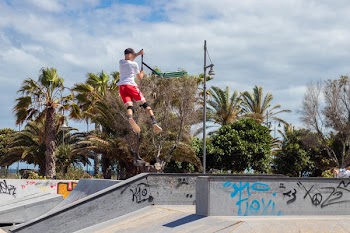 Man Doing Kick Scooter Aerial Trick on Park