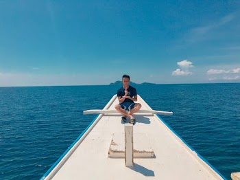 Man Doing Lotus Position on Boat