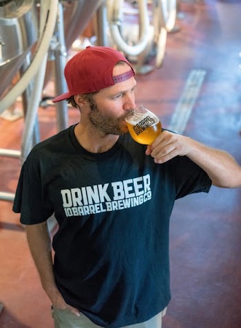 Man Drinking Beer and Looking at His Left Side