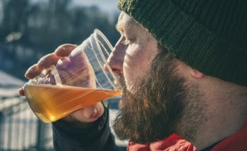 Man Drinking While Holding Plastic Cup