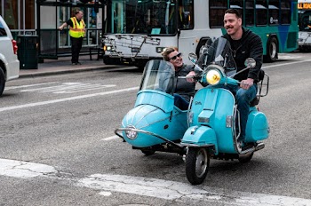 Man Driving Teal Motorcycle With Cab And Passenger On Road
