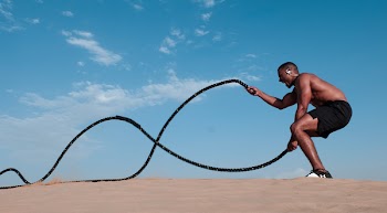 Man Exercising Using Two Ropes