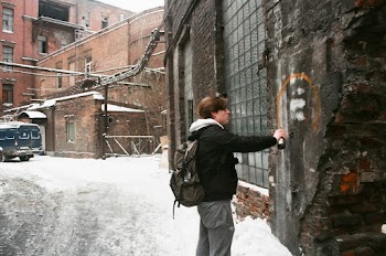 Man Facing Black Metal Wall