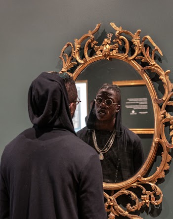 Man Facing Brown Framed Mirror