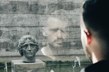 man facing head bust