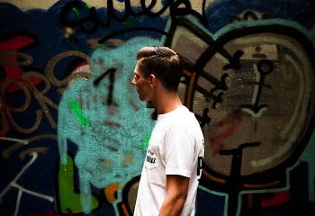 Man Facing Sideways Looking at Wall Painting