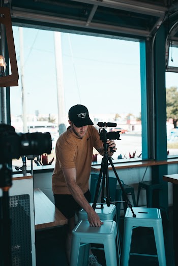 Man Fixing His Camera's Tripod