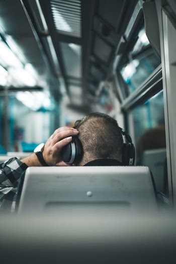 man fixing his headphones