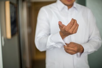 Man Fixing His Sleeves