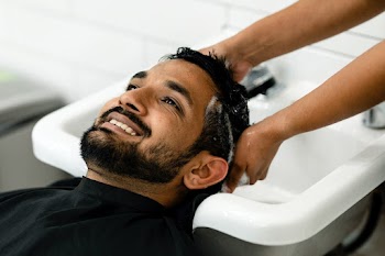 Man getting a hair wash at a barber shop  | Free stock photo | High Resolution image