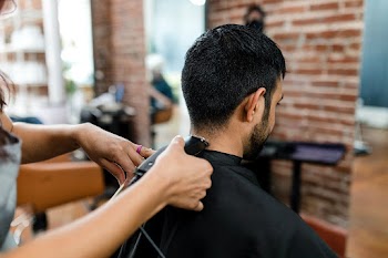 Man getting a haircut from a hair stylist at… | Free stock photo | High Resolution image