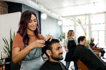 Man getting a haircut from a hair stylist at… | Free stock photo | High Resolution image