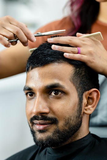 Man getting a haircut from a hair stylist at… | Free stock photo | High Resolution image