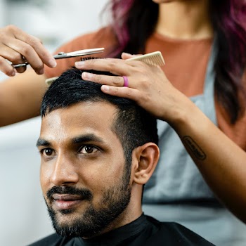 Man getting a haircut from a hair stylist at… | Free stock photo | High Resolution image