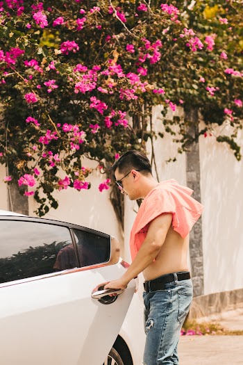 Man Getting in a White Car