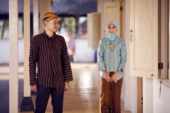 Man Glancing at Woman Standing Beside Window