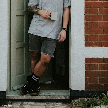 Man having a coffee by his doorway, watching the outside world | Free  photo - 2332572