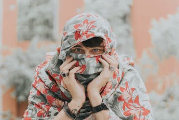 Man Hiding His Face Using Floral Scarf