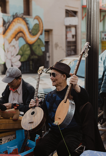 Man Holding 2 Guitar