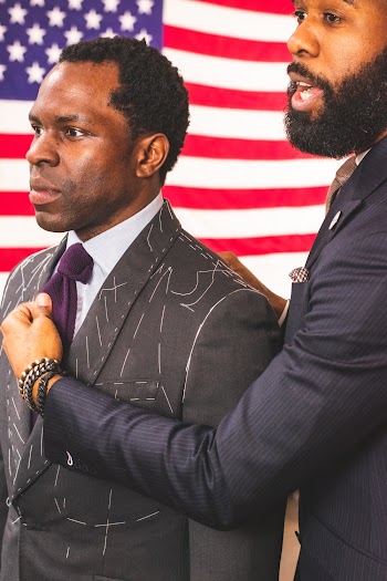 Man Holding Another Man's Purple Necktie