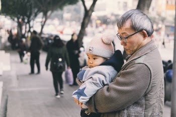 Man Holding Baby At Park