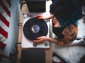 man holding black and gray vinyl player