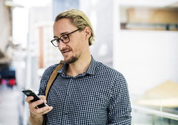 Man Holding Black Android Smartphone While Smiling