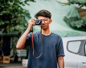 Man Holding Black Camera