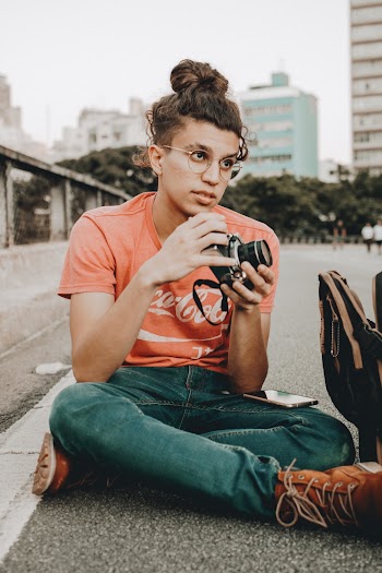 Man Holding Black Dslr Camera