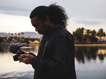 Man Holding Black Dslr Camera