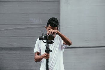 Man Holding Black Dslr Camera