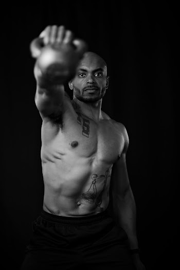 Man Holding Black Kettlebell