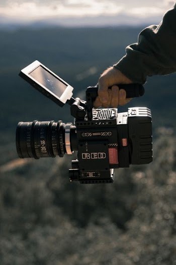 man holding black professional camcorder